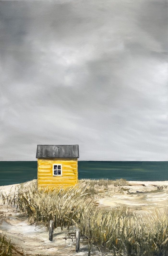 Yellow beach hut in coastal dunes overlooking the ocean under a soft grey sky, fine art print