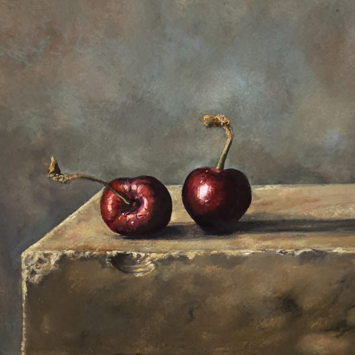 Cherry still life fine art print featuring two dark red cherries on a stone ledge with soft moody background